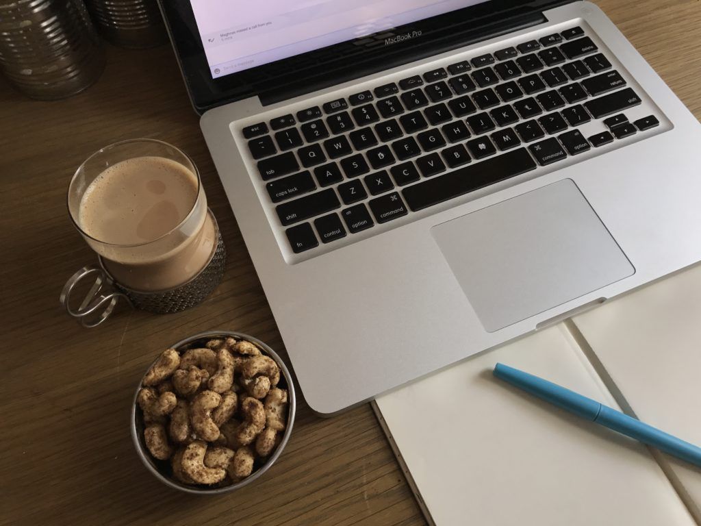 laptop, chai, notebook and cashews
