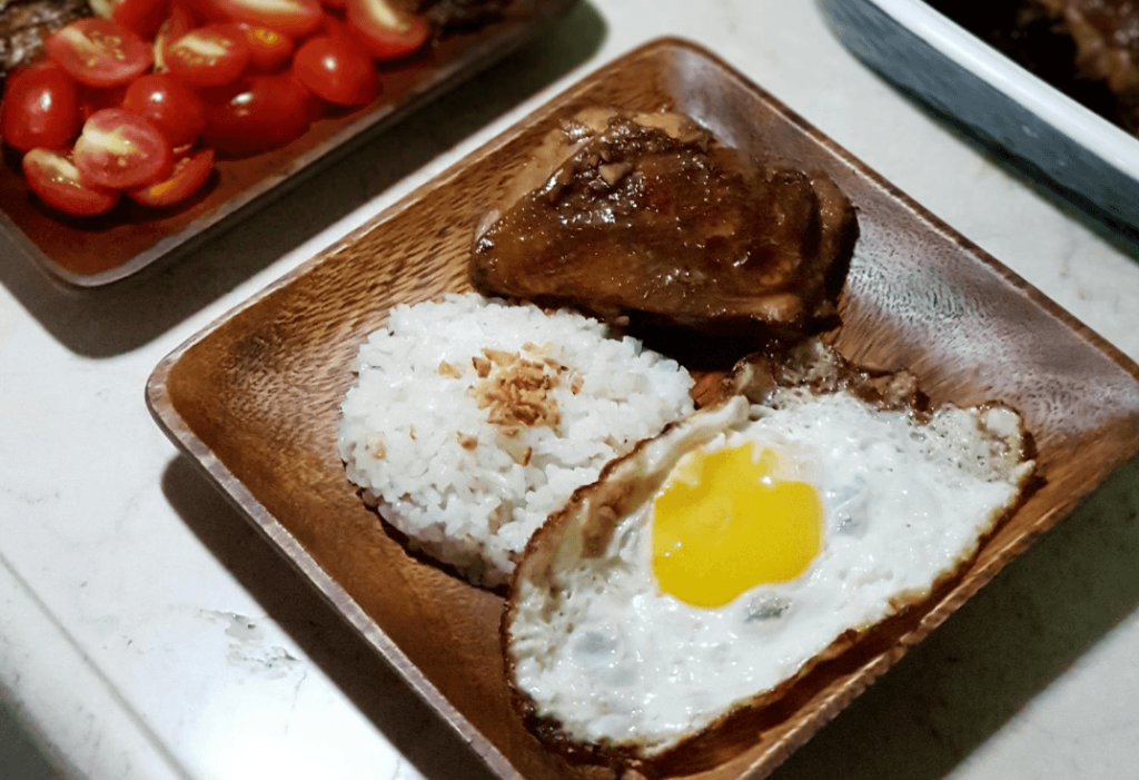 crispy fried egg as a part of home-cooked filipino feast