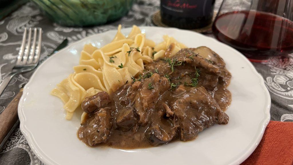 a delicious serving of homemade beef bourguignon, with buttered egg noodles