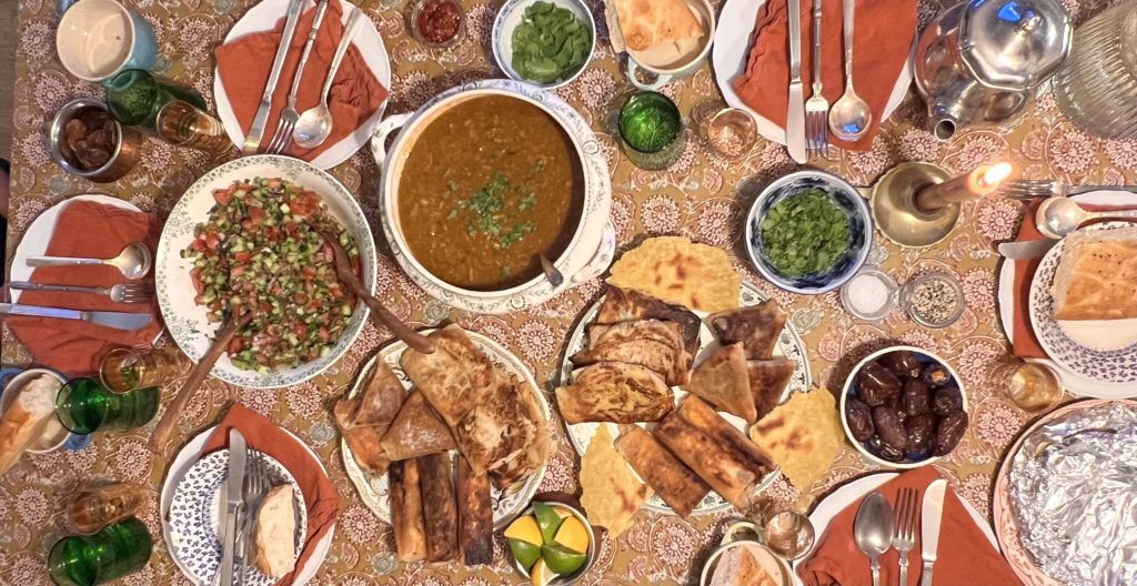 table full of homemade algerian food for soraya's algerian iftar, chorba